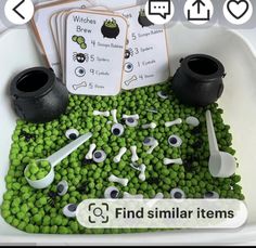 a bowl filled with lots of green beans next to two black pots and spoons