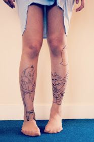 a woman's legs with tattoos on them