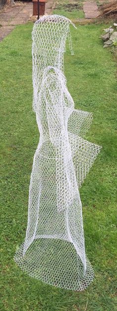 a wire sculpture in the shape of a woman