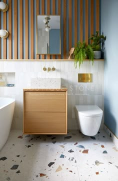 an instagram page with a white toilet, sink and wooden cabinet in the bathroom