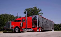 a red semi truck parked on the side of the road