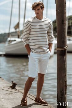 The laid-back "Nautical Sloane" look is a fresh take on the classic Old Money style. This effortlessly chic ensemble features a Saint James striped Breton shirt, a timeless wardrobe staple that exudes casual elegance. Paired with crisp white Hackett chino shorts and rich brown leather Dubarry boat shoes, this look strikes the perfect balance between relaxed coastal charm and refined British sensibility. Embrace the understated luxury of the "Nautical Sloane" aesthetic and infuse your summer wardrobe with a touch of timeless maritime-inspired style. Click through for more inspiration to create your own unique looks that capture the essence of this enduring trend. Sloane Ranger Style Preppy, Men’s Coastal Fashion, Coastal Men’s Outfits, Vintage British Sportsman, Breton Shirt