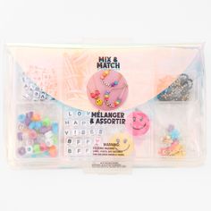 an assortment of buttons and beads in a plastic case on a white background with the words mix & match written below it