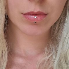 a woman with blonde hair wearing a nose piercing