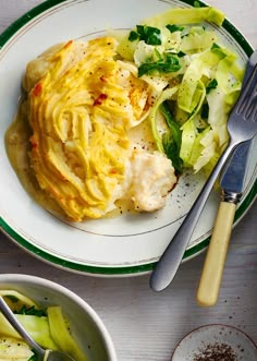 a white plate topped with food next to two bowls