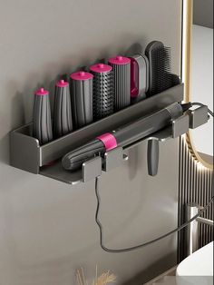 a hair dryer and combs are hanging on the wall