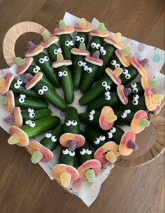 there is a platter filled with cucumbers and gummy bears in the shape of eyes