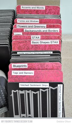 several stacks of business cards sitting on top of each other next to a computer keyboard