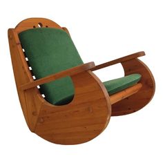 a wooden rocking chair with green cushions on it's seat and backrests