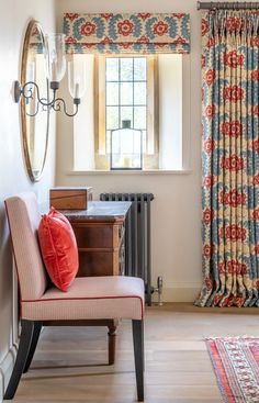 a living room with a chair, rug and window