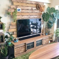 a living room filled with furniture and a flat screen tv mounted to the side of a wall