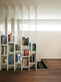 there are many bookshelves in the room and one is full of books on it