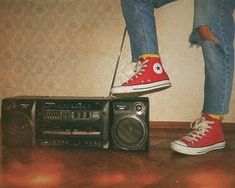 a person standing on top of a radio next to a boombox and speaker system