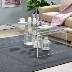 a glass coffee table with candles on it