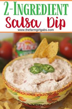 a bowl filled with salsa dip surrounded by tortilla chips