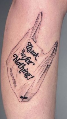 a tattoo on the leg of a person with a book