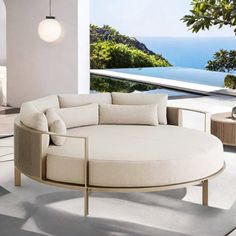 a living room filled with furniture and an ocean view