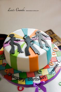 a birthday cake decorated with paper cutouts