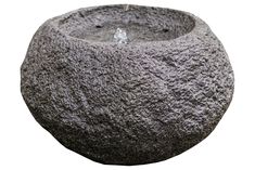 a stone bowl with water in it is shown on a white background for use as a planter