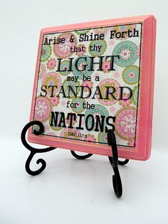 a pink and black stand with a quote on it that says, praise & shine forth that city light may be a standard for the nations