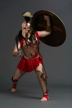 a man dressed in roman armor holding a shield