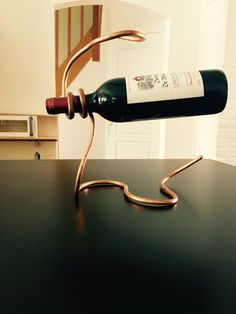 a wine bottle that is sitting on top of a table next to a corkscrew