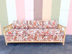 a couch sitting in front of a colorful wall