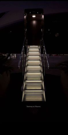 an escalator with stairs lit up at night