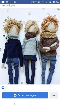 three dolls are laying on top of each other, one is wearing a sweater and the other has a scarf