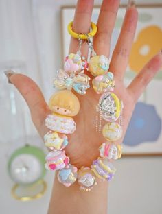 a hand with some beads and charms on it