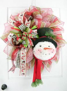 a christmas wreath with a snowman on it