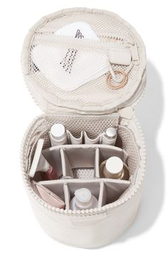 the inside of a white bag with cosmetics in it