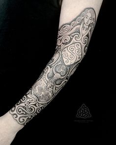 a person with a black and white tattoo on their arm