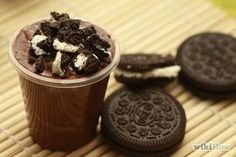 an ice cream sundae with oreo cookies on the side, and chocolate milkshake