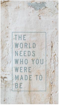 the world needs who you were made to be written on a stone wall with green lettering