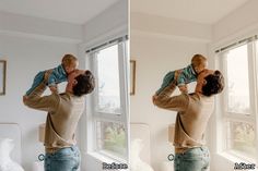 a man holding a baby up to his face while standing in front of a window