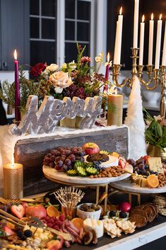 a table topped with lots of food and candles