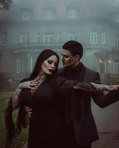 a man and woman dressed in gothic clothing