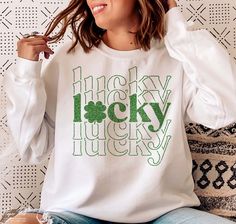 a woman sitting on a couch wearing a white shirt with the words lucky lucky printed on it