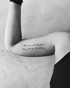 a woman with a tattoo on her arm saying, she can hold your story so strong