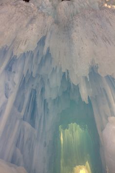 the inside of an ice cave with snow on it