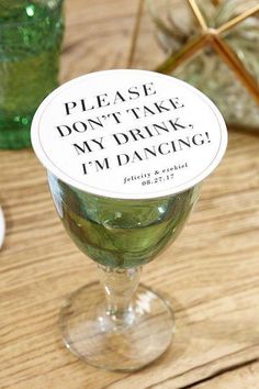 a wine glass with a label that says please don't take my drink, i'm dancing