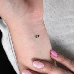 a woman's wrist tattoo with an infinite symbol on the left side of her arm