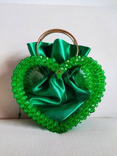 The handbag for Valentine's Day. The handbag is made of green colored acrylic beads. Inside there is a satin bag. Green Beaded Rectangular Evening Bag, Green Beaded Bag For Party, Green Beaded Bags For Parties, Green Handheld Evening Bag, Elegant Green Bag With Pearl Handle, Handmade Green Bag For Party, Green Beaded Evening Bag For Party, Green Pouch Evening Bag, Green Handheld Clutch For Evening