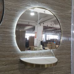 a round mirror mounted to the side of a wall