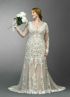 a woman in a wedding dress holding flowers