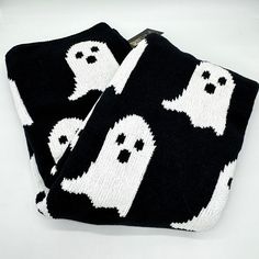 two black and white towels with ghost faces on them, one has a zipper in the middle