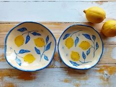 two blue and white bowls with lemons on them