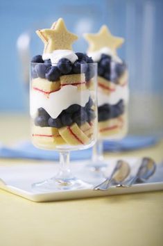 two desserts with blueberries, strawberries and stars in them on a table