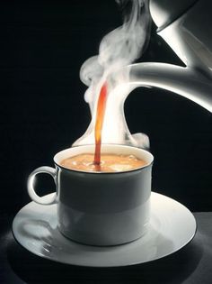 steaming hot chocolate in a white cup on a saucer